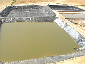 Solar evaporation pond used to reduce seepage losses, soil pollutions, water pollutions, hdpe geomembrane liners protect soil & ground water beneath, Climax,India - Image